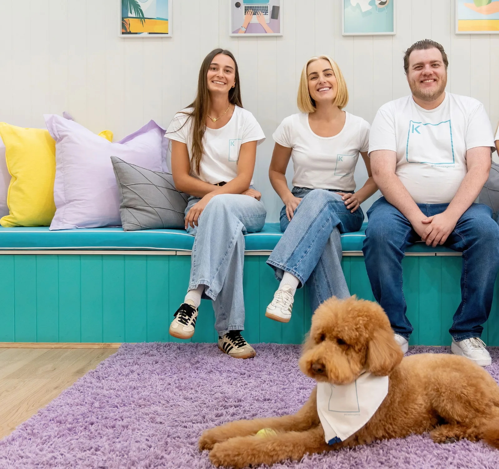 The K.I.S.S team smiling on the office lounge with Harley